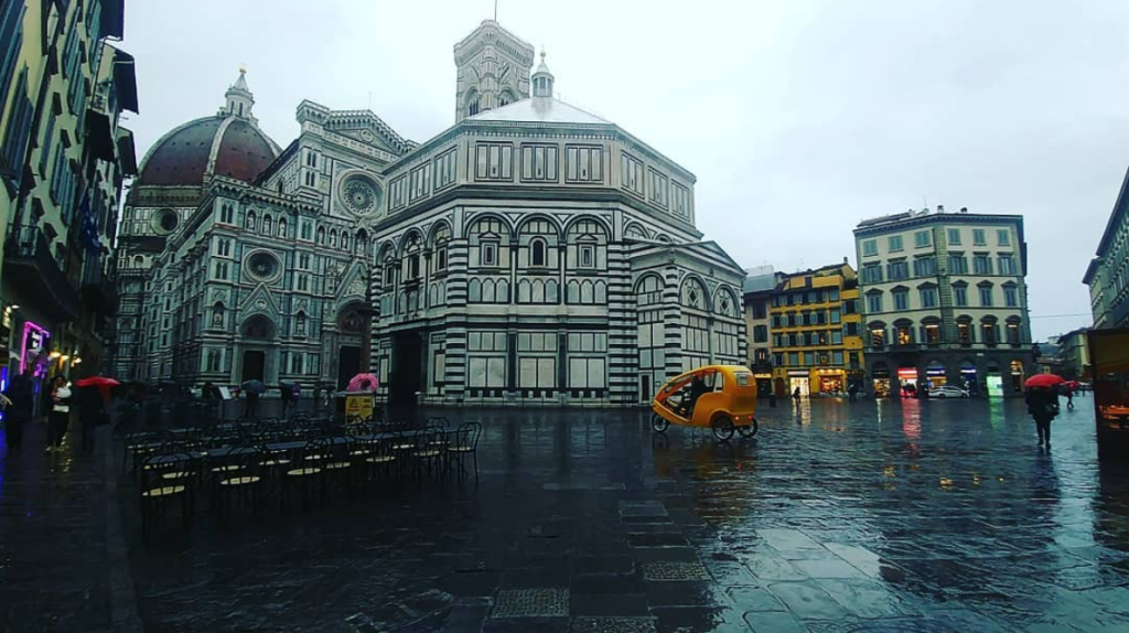 A normally bustling and crowded Piazza San Giovanni in the center of Florence is quiet. The rain probably also had something to do with this, but it is still stark. Lone pedicab guy can't even find a fare in the freezing rain.